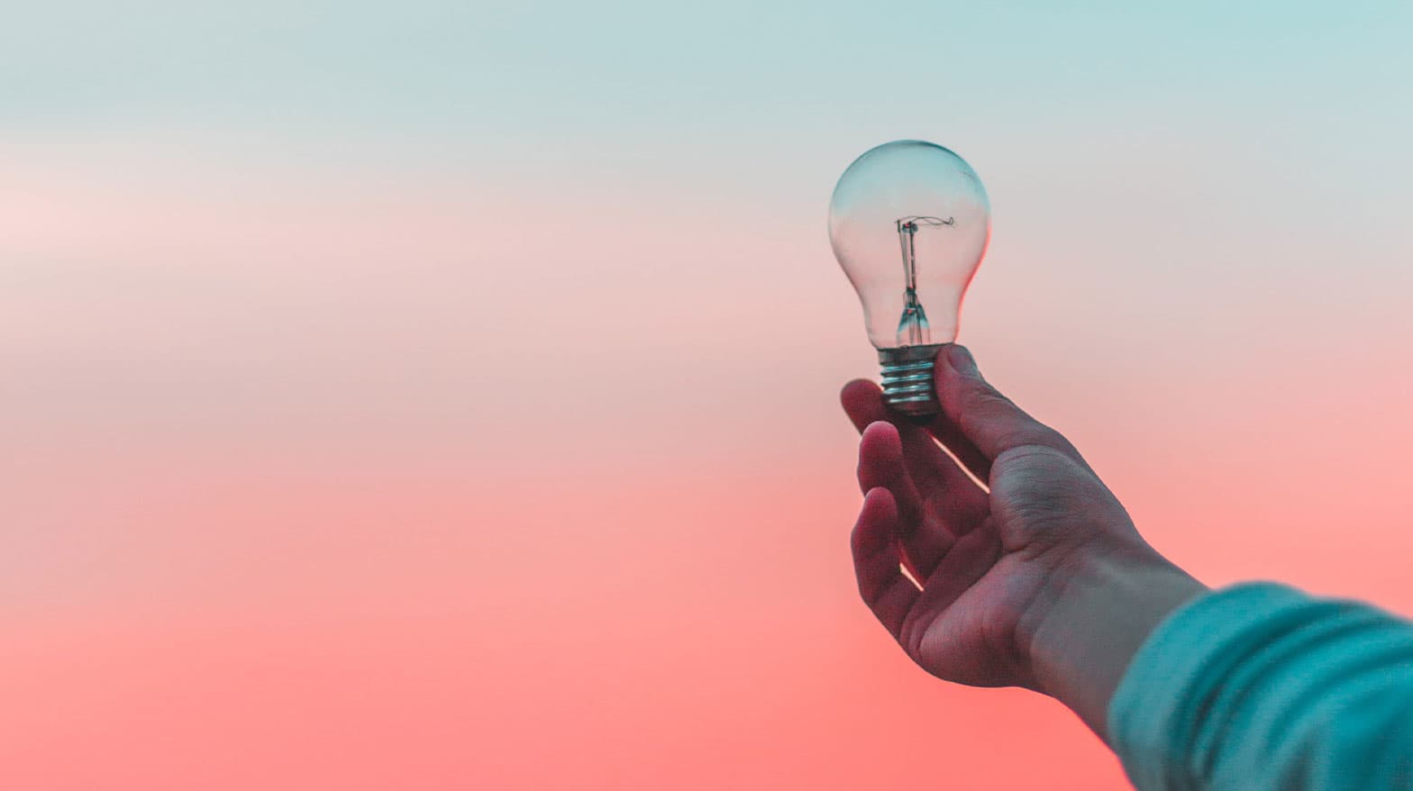 A man holding a lightbulb illustrating essential business marketing ideas