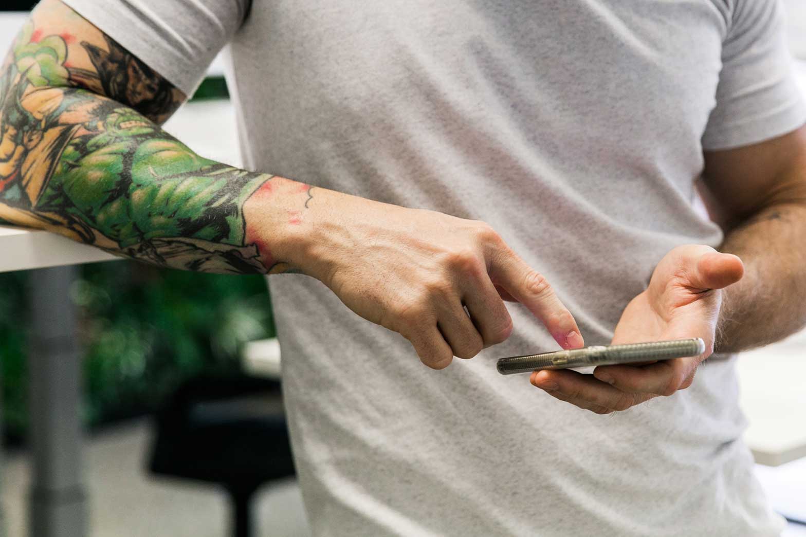 A man interacting with a chat bot on his mobile phone