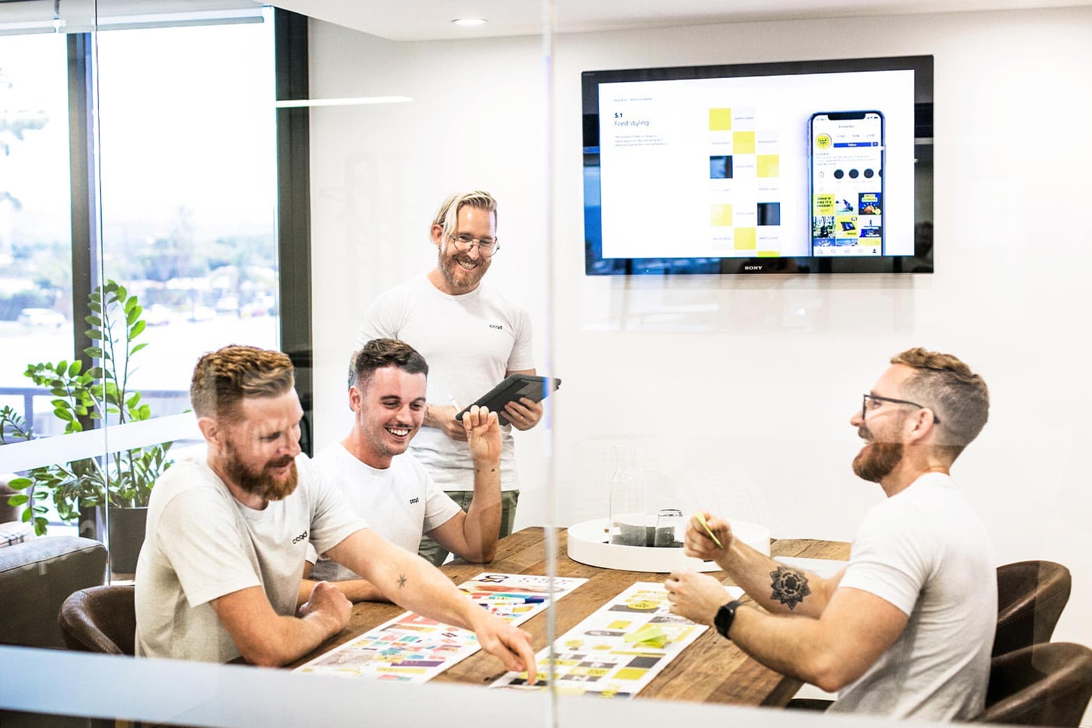 Embark team members discussing a brand strategy in their meeting room