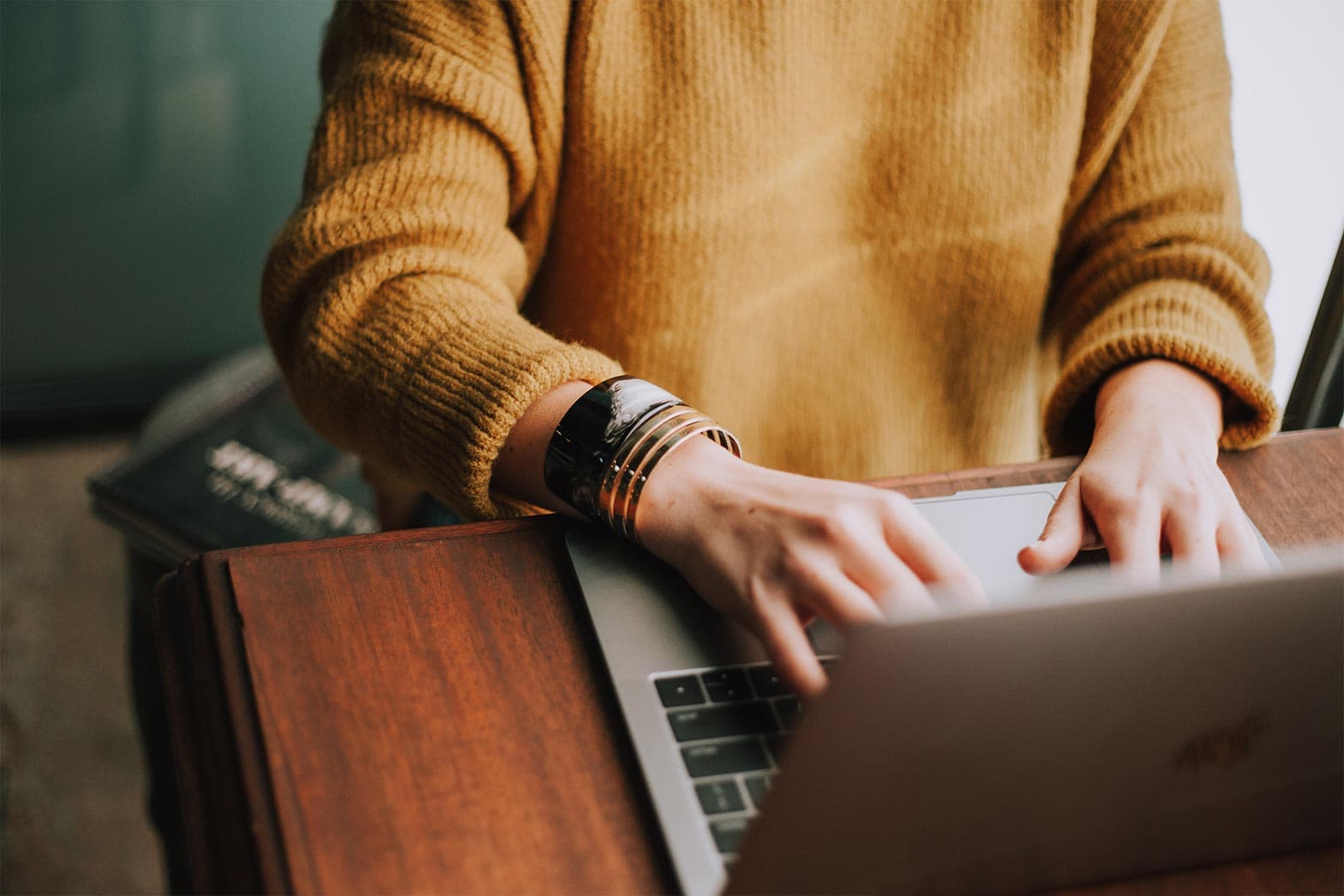 A person using a laptop to research personal branding mistakes