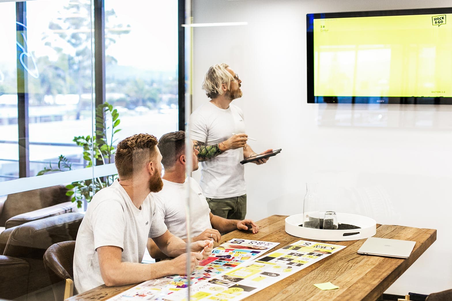 The Embark Agency team discussing what makes a brand in their meeting room