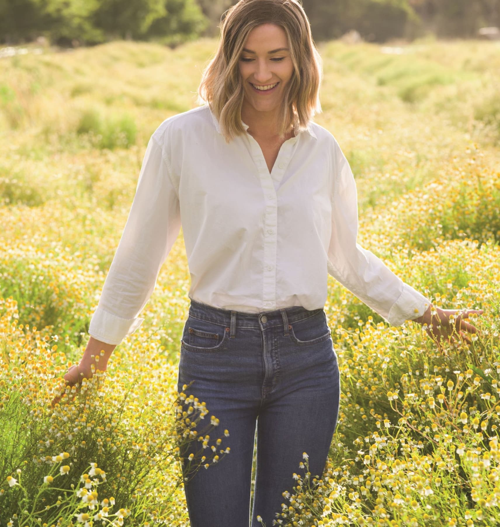 Wellness Wander event photo of woman in a field of flowers