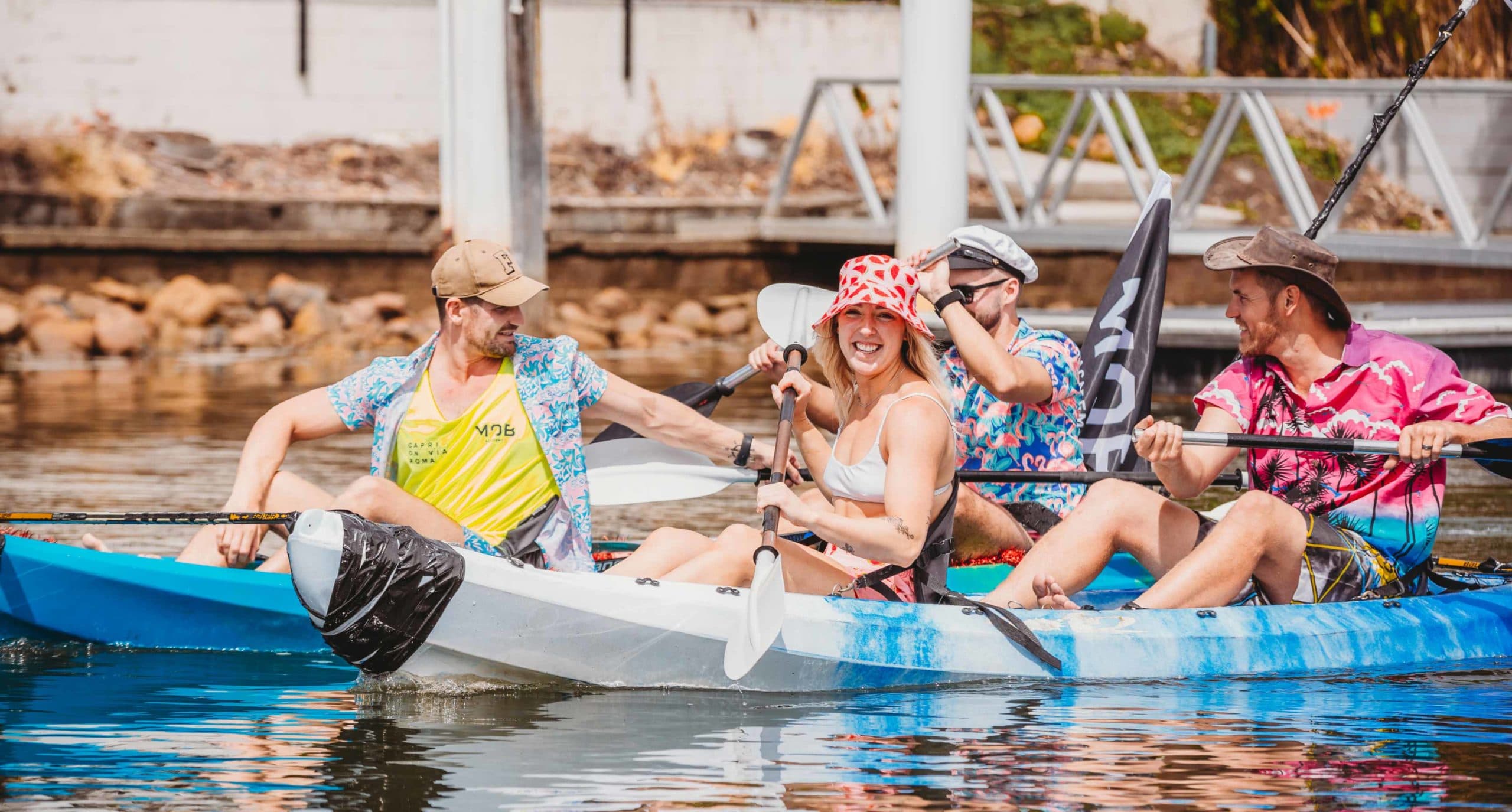 A group of young people paddling at the Men of Business Academy Capri Paddle