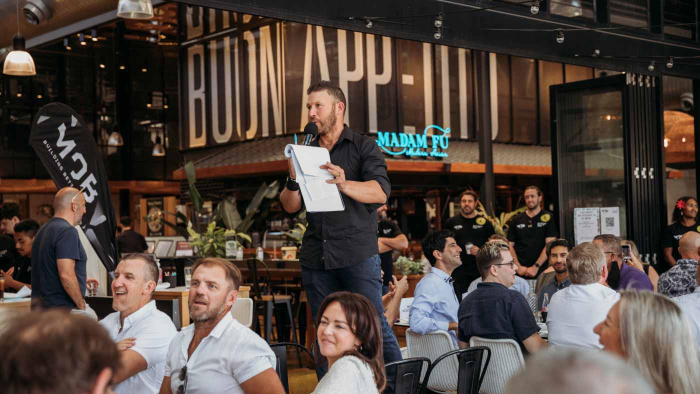 A man making an announcement to a group of people