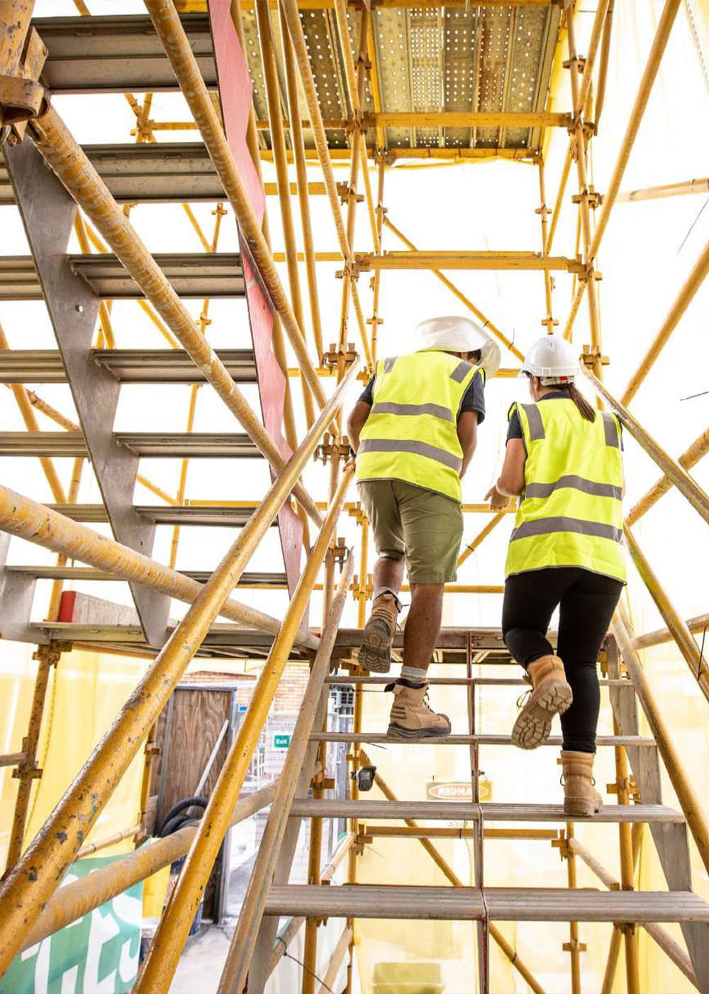 Alder construction two people going up the stairs