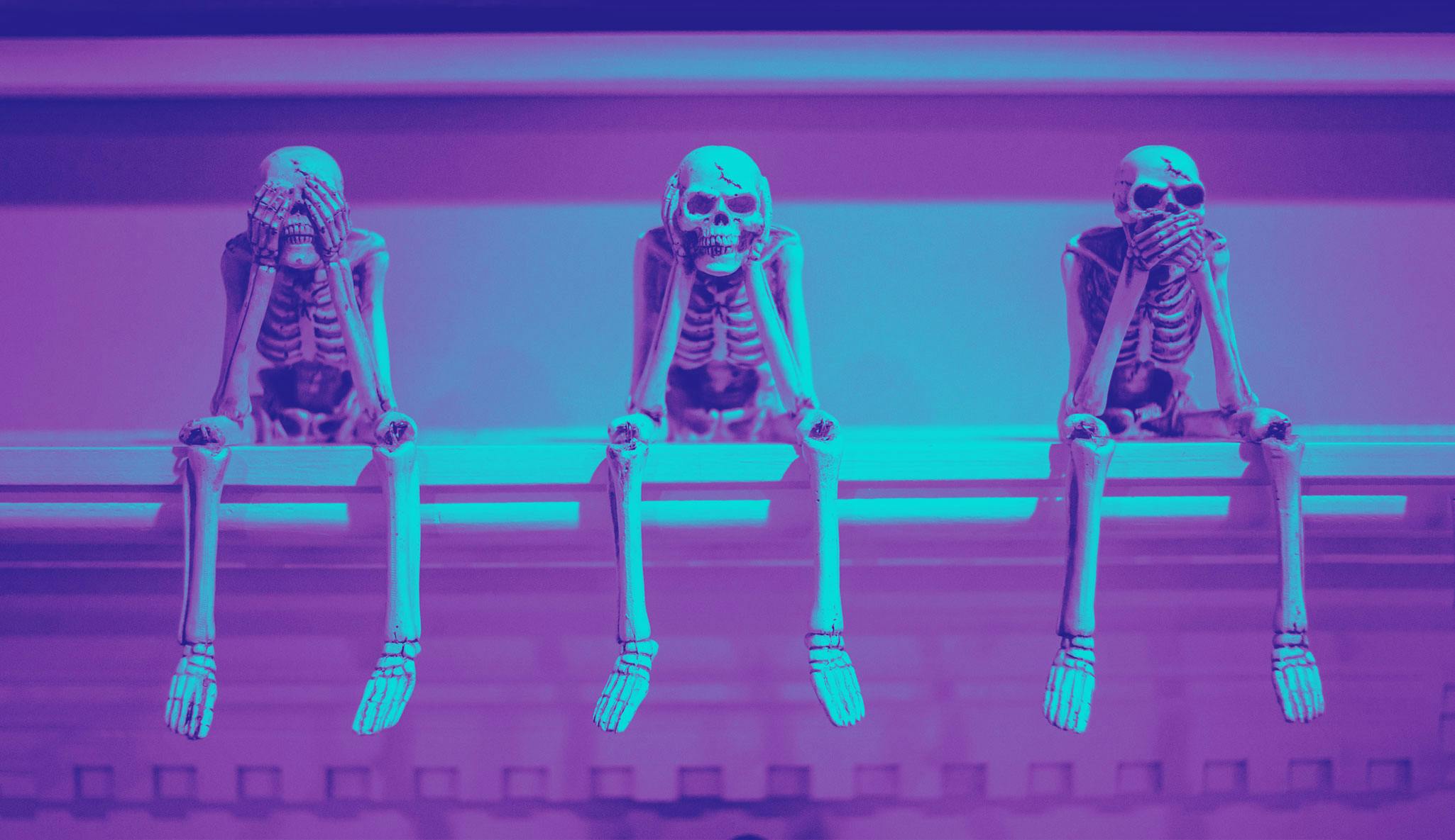 Skeletons sitting on a bench