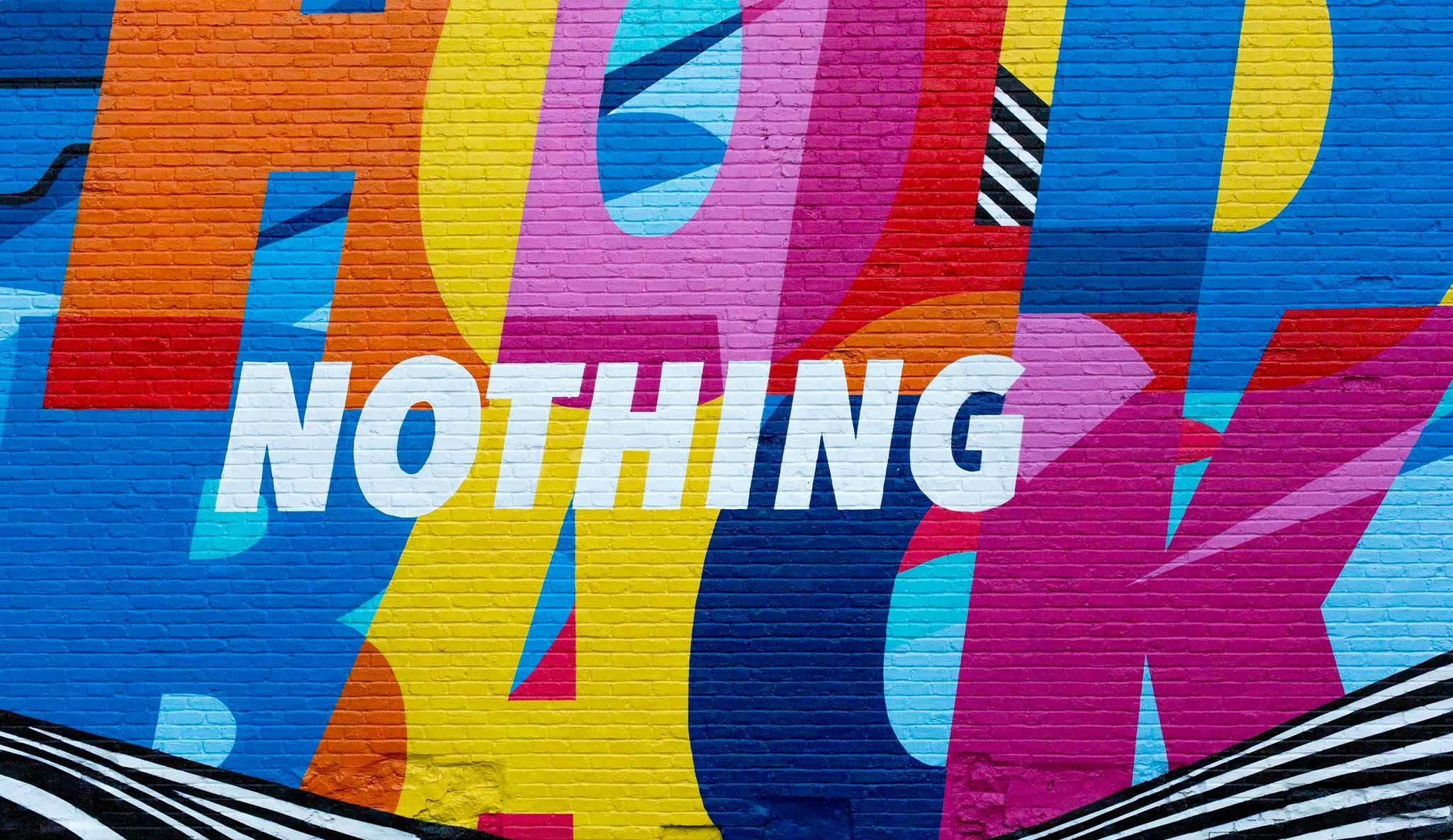 A colourful graffiti wall with the word 'Nothing' in the middle