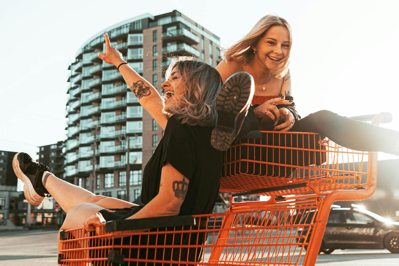 Women having fun in a shopping trolley