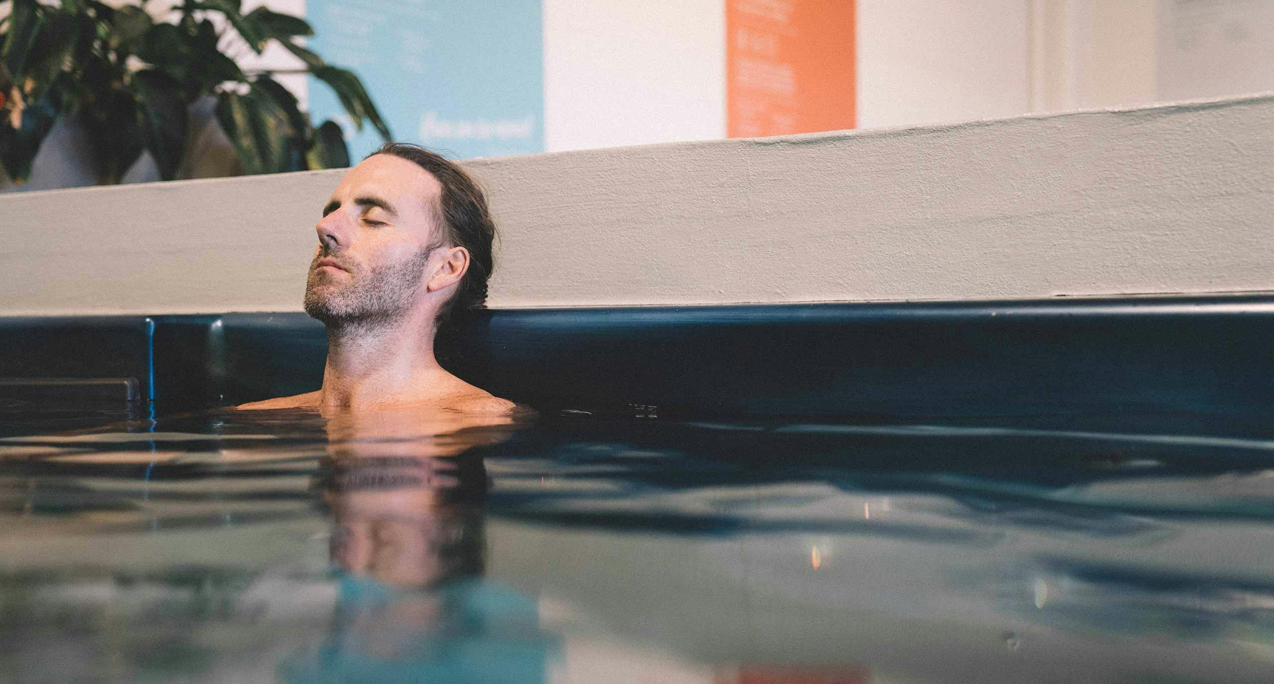 A man relaxing in a pool of water