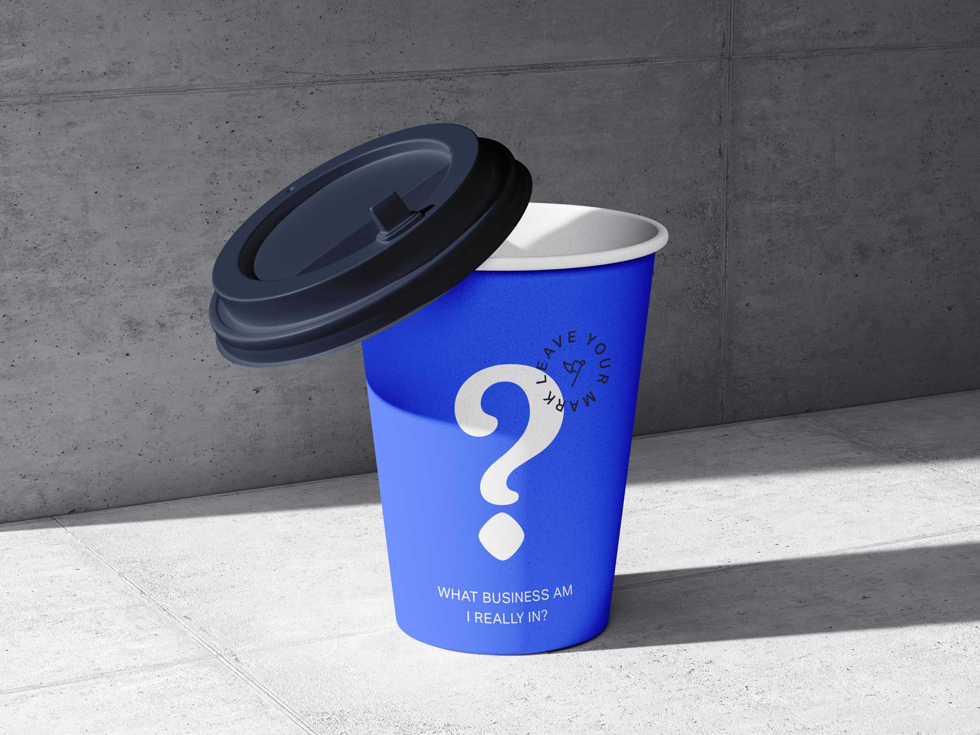 A blue coffee takeaway cup on a concrete background with a question mark and words saying what business are you really in?