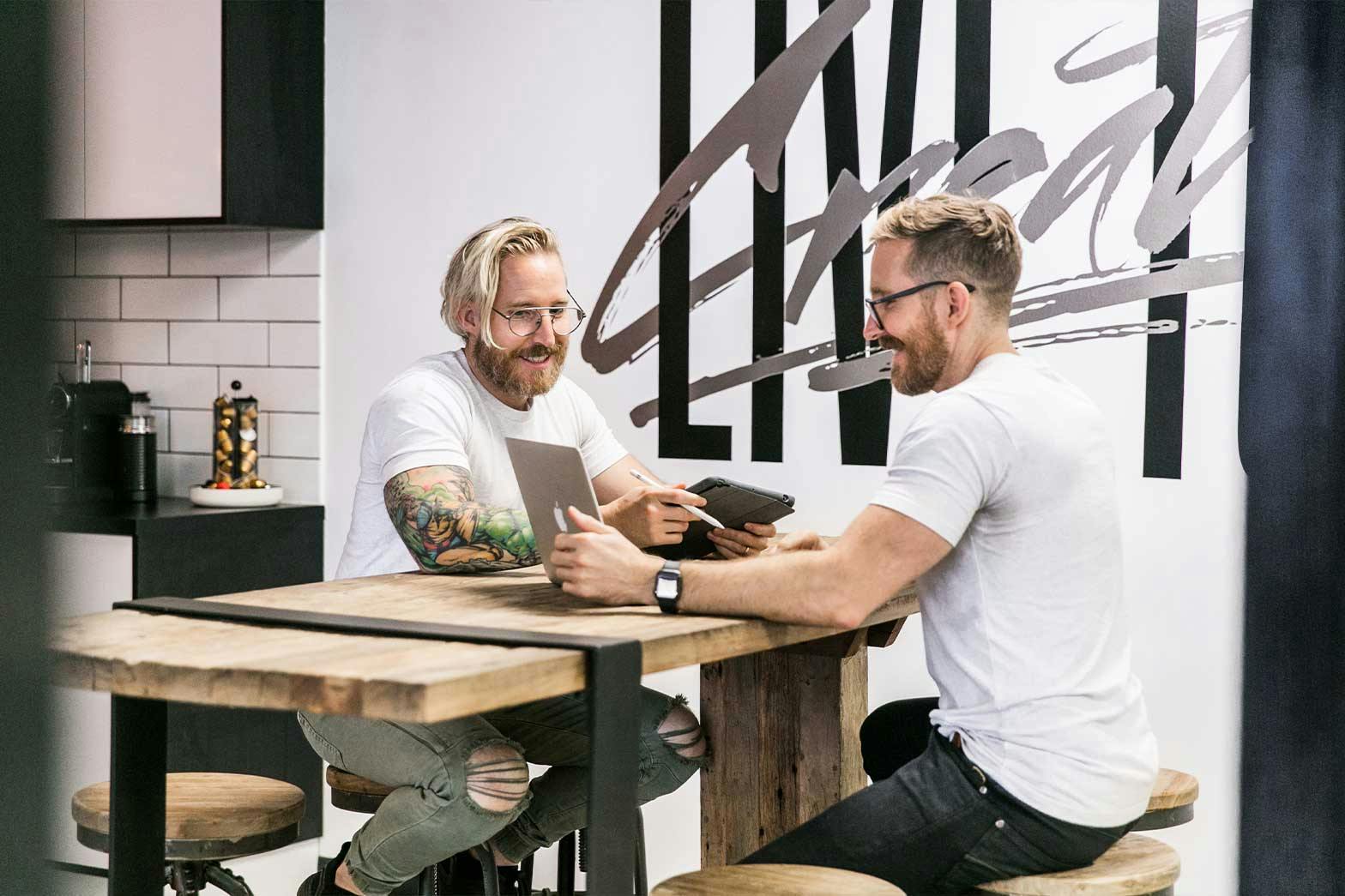 Two people sitting at a table doing brand strategy