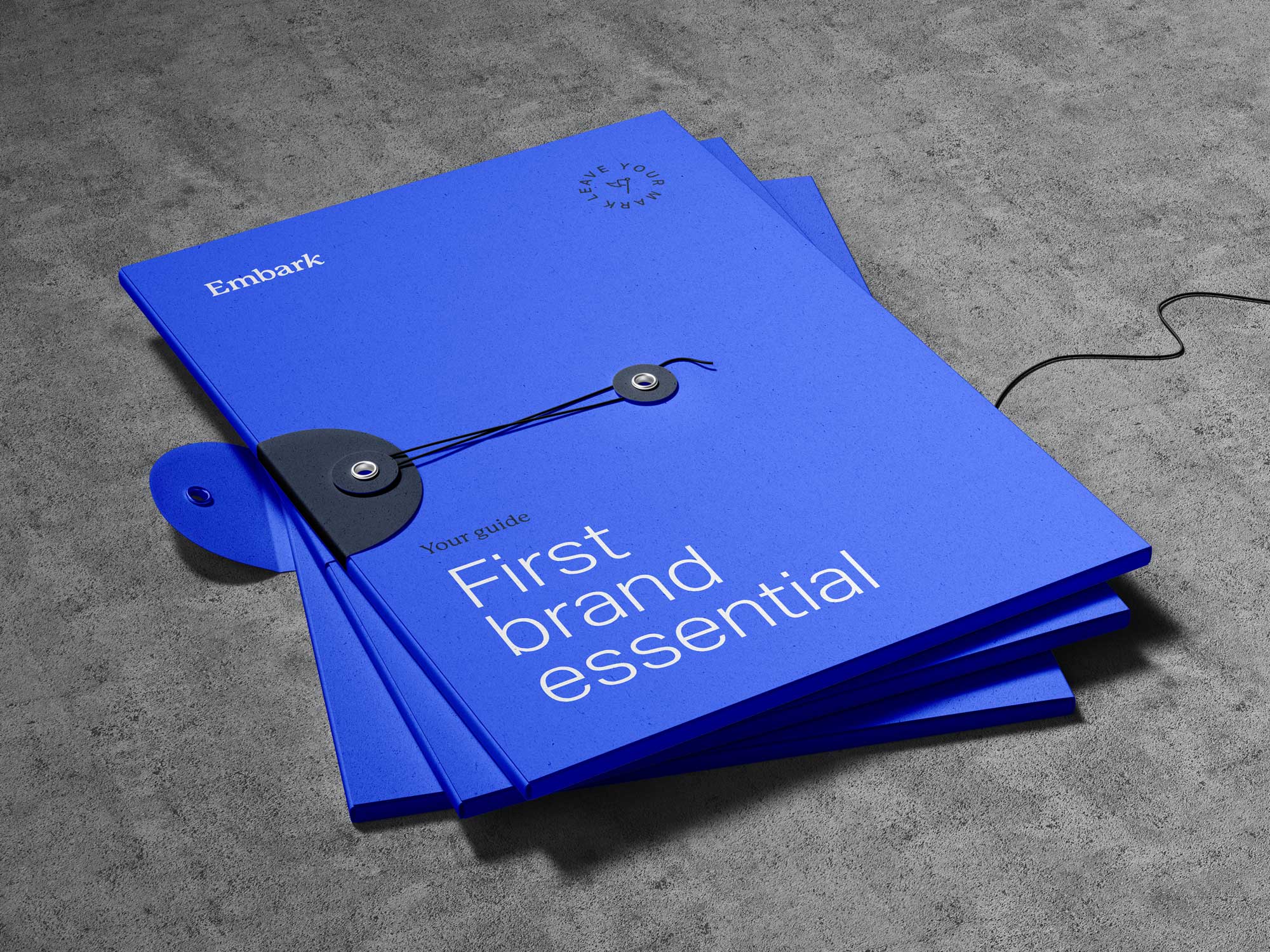 3 string bound blue folders with the Embark logo on the front and the words saying first brand essentials