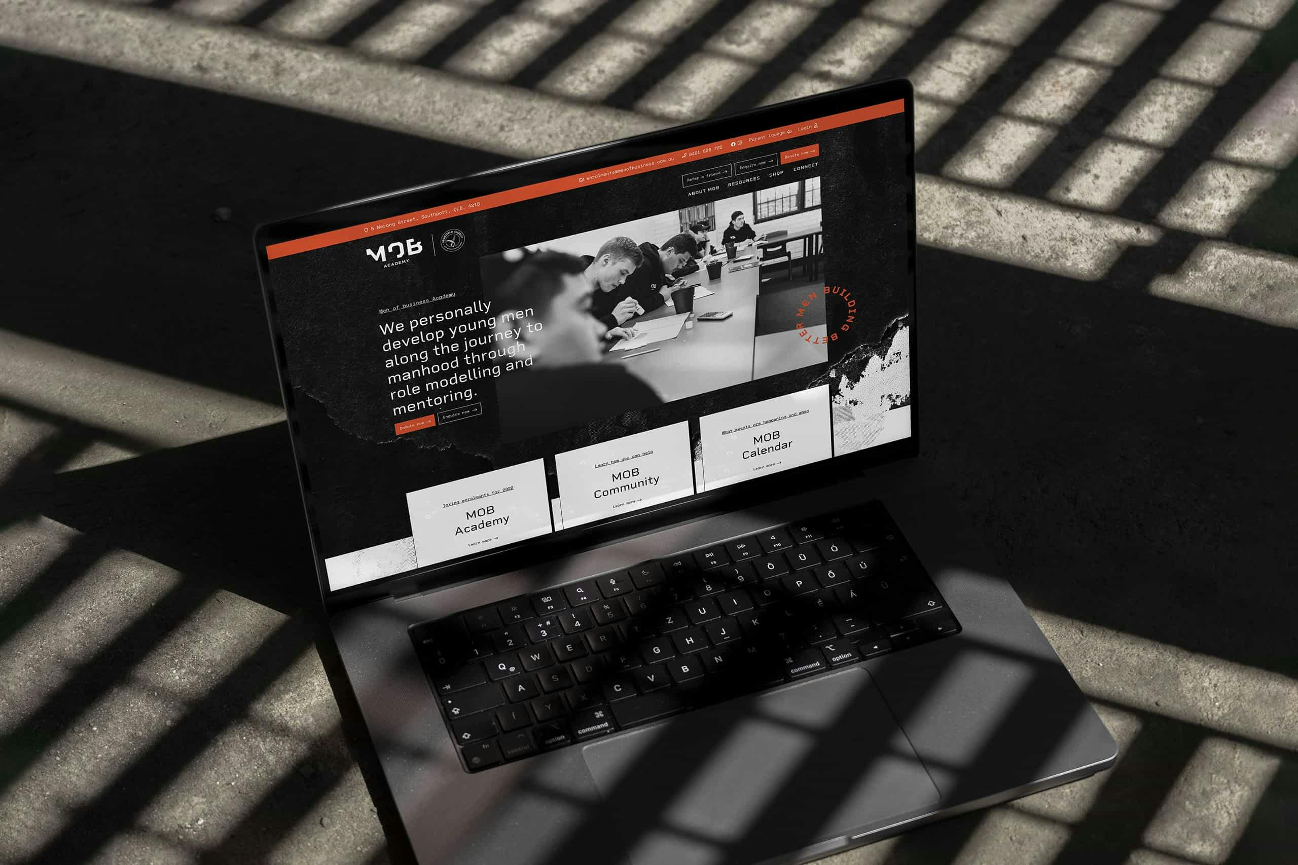 Men of Business website displayed on a laptop